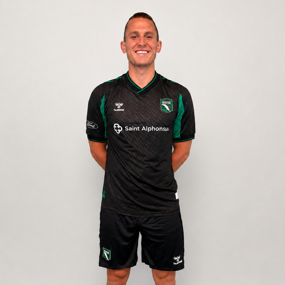 Person wearing a black sports uniform with green accents on a white background
